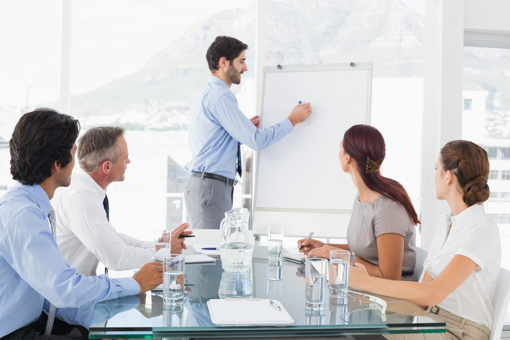 Business man giving a presentation to his team